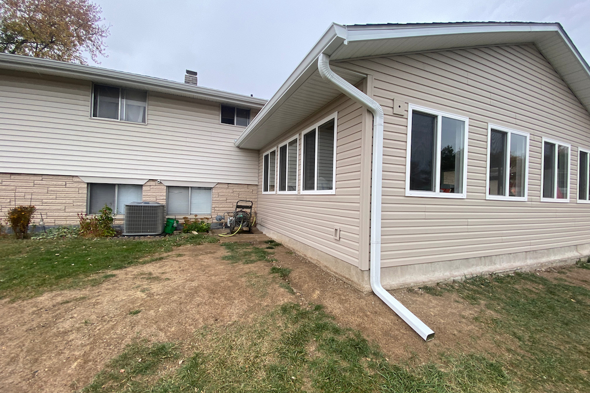 Seamless gutter and downspout installation
